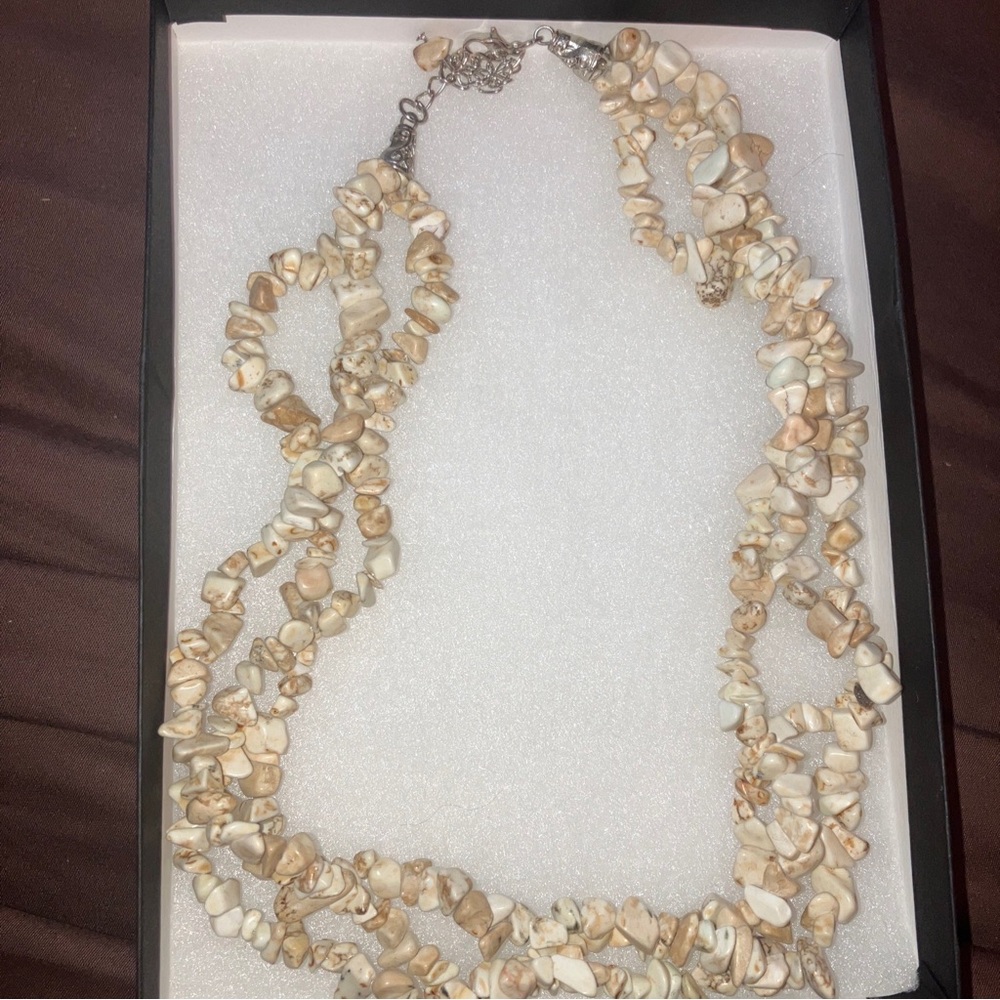 Vintage three strand natural shell necklace with silver tone closure and clasp
